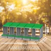 A product shot of a multi-compartment nesting box for chickens, placed on a wooden surface with a blurred outdoor background. Produktbild-Vorschau
