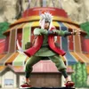 A statue of Jiraiya from Naruto Shippuden in a dynamic pose, with a stylized building in the background. Podgląd zdjęcia produktu