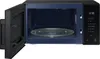 An open microwave with the interior light on, showing the turntable and control panel. Anteprima dell’immagine prodotto