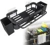 A black kitchen sink caddy with attached containers and hooks, mounted on a wall above a sink. Produktbild-Vorschau