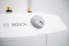 Close-up of the top of a white Bosch appliance with a control knob and the Bosch logo. Voir les images du produit