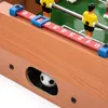 A close-up view of a foosball table, focusing on the score markers and a small soccer ball in a side opening. Podgląd zdjęcia produktu