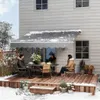 People sitting on a deck under an awning in the snow. Náhľad obrázku produktu