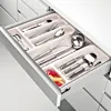 A cutlery organizer drawer with various kitchen utensils. Produktbild-Vorschau