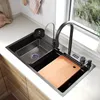 A modern kitchen sink with various accessories, including a faucet, cutting board, and a cup rinser. Náhľad obrázku produktu