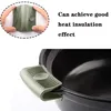A close-up of a green silicone pot handle holder attached to a black pot, with a smaller inset image showing hands holding the holder and text describing its heat insulation properties. Produktbild-Vorschau