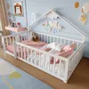 A child's bedroom with a white wooden bed, pink and white bedding, and decorative elements on the wall. Podgląd zdjęcia produktu