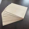 A stack of thin wooden boards fanned out on a dark surface. Produktbild-Vorschau