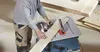 A person is using a table saw to cut a piece of wood. Voir les images du produit