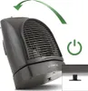 A black TROTEC fan heater is shown from a low angle, with a green arrow indicating oscillation and a green power button icon. A close-up inset shows a black plastic foot. Podgląd zdjęcia produktu