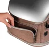 A hand is reaching into a zippered pocket on a brown pet carrier. Náhľad obrázku produktu