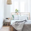 A bedroom scene with a bed and a nightstand. Anteprima dell’immagine prodotto