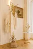 A hallway with a coat rack, painting, and side table. Produktbild-Vorschau