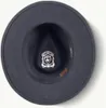 The inside of a dark-colored hat is shown, with a logo and a leather band visible. Produktbild-Vorschau