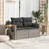 A patio setting with a two-seater sofa, plants, and a rug. Podgląd zdjęcia produktu