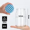 A hand holds a blue checkered lid above a clear glass jar, with measurement indicators and weight information displayed. Produktbild-Vorschau