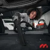 A woman is vacuuming the trunk of a car. Produktbild-Vorschau