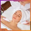 A woman is receiving a facial treatment with a device. Produktbild-Vorschau
