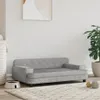 A pet sofa is placed on a rug in a room with a white wall and a plant in a pot. Anteprima dell’immagine prodotto