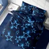A bed with dark blue bedding featuring a neon blue star pattern, placed in a bedroom setting. Produktbild-Vorschau