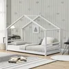 A child's bed with a house frame in a bedroom with star-patterned wallpaper. Náhľad obrázku produktu