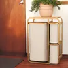 A laundry basket with three bags next to a wooden door and a potted plant on top. Podgląd zdjęcia produktu