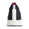 Back view of a black sneaker with white accents and a red, white, and blue logo tab. Produktbild-Vorschau