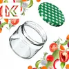 A clear glass jar and a green checkered lid are shown against a white background, surrounded by various fresh vegetables and herbs. Anteprima dell’immagine prodotto