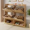 A wooden shoe cabinet with rattan doors and metal legs, filled with shoes. Anteprima dell’immagine prodotto