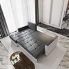 A sectional sofa is shown in a modern living room setting with marble flooring and sheer curtains. Produktbild-Vorschau