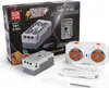 The image shows the packaging and contents of a Mould King M-0006 4.0 Powered Module set, including the power module itself, a remote control, and a charging cable. Produktbild-Vorschau