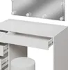A close-up view of a white vanity table with an open drawer and a stool. Produktbild-Vorschau