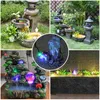 A collage of four images showcasing different garden fountains with LED lighting. Produktbild-Vorschau