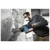 A man is using a rotary hammer to break apart a wall. Produktbild-Vorschau