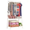 A white metal garment rack with clothes and folded bedding. Náhled obrázku produktu