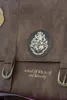 A close-up of a brown leather bag with the Hogwarts crest and text. Anteprima dell’immagine prodotto