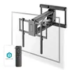A motorized TV wall mount is shown attached to a wall, with a transparent outline of a TV in front of it. A smartphone and a remote control are displayed in the foreground. Podgląd zdjęcia produktu