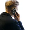 A person is holding a smartphone to their ear, viewed from behind. Produktbild-Vorschau