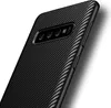 A close-up, angled view of the back of a black smartphone case with a carbon fiber texture. Produktbild-Vorschau