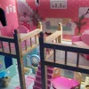 A dollhouse interior with multiple levels and furniture. Voir les images du produit