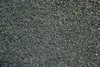 A close-up, overhead view of a pile of small, dark gray gravel. Produktbild-Vorschau