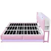 A pink upholstered bed frame with a slatted base, shown from the side against a white background. The headboard has integrated storage compartments and LED lighting. Produktbild-Vorschau
