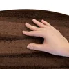 A hand is touching a brown carpeted stair mat. Produktbild-Vorschau