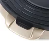 A close-up view of a black grill surface with raised ridges and a gold-colored handle or base. Voir les images du produit