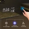 A hand touching a smart mirror with a digital display showing weather and time, with instructional graphics below. Produktbild-Vorschau