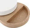 A close-up view of a round coffee table with a white top and a wooden base featuring a recessed section. Produktbild-Vorschau