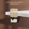 A cup holder attached to the edge of a white desk, holding a disposable coffee cup. Anteprima dell’immagine prodotto