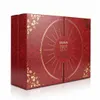 A red and gold advent calendar with a circular design on the front. Produktbild-Vorschau