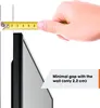 A hand holding a measuring tape next to a TV wall mount, indicating the minimal gap with the wall. Produktbild-Vorschau