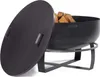 A black metal fire pit with a lid partially open, filled with firewood, resting on a black metal stand. Produktbild-Vorschau